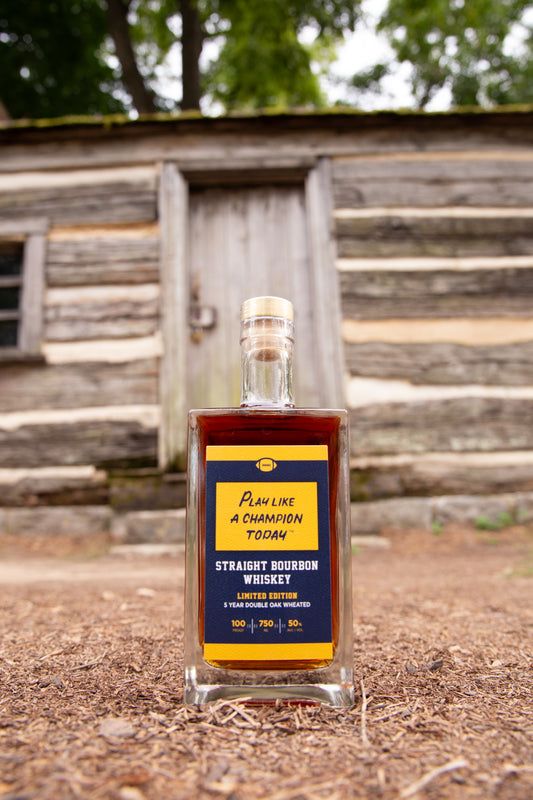 Bottle of PLACT pictured outside by a log cabin